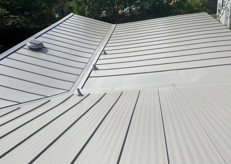 Solar attic fan installed on a metal roof for Roof Ventilation in Speedway